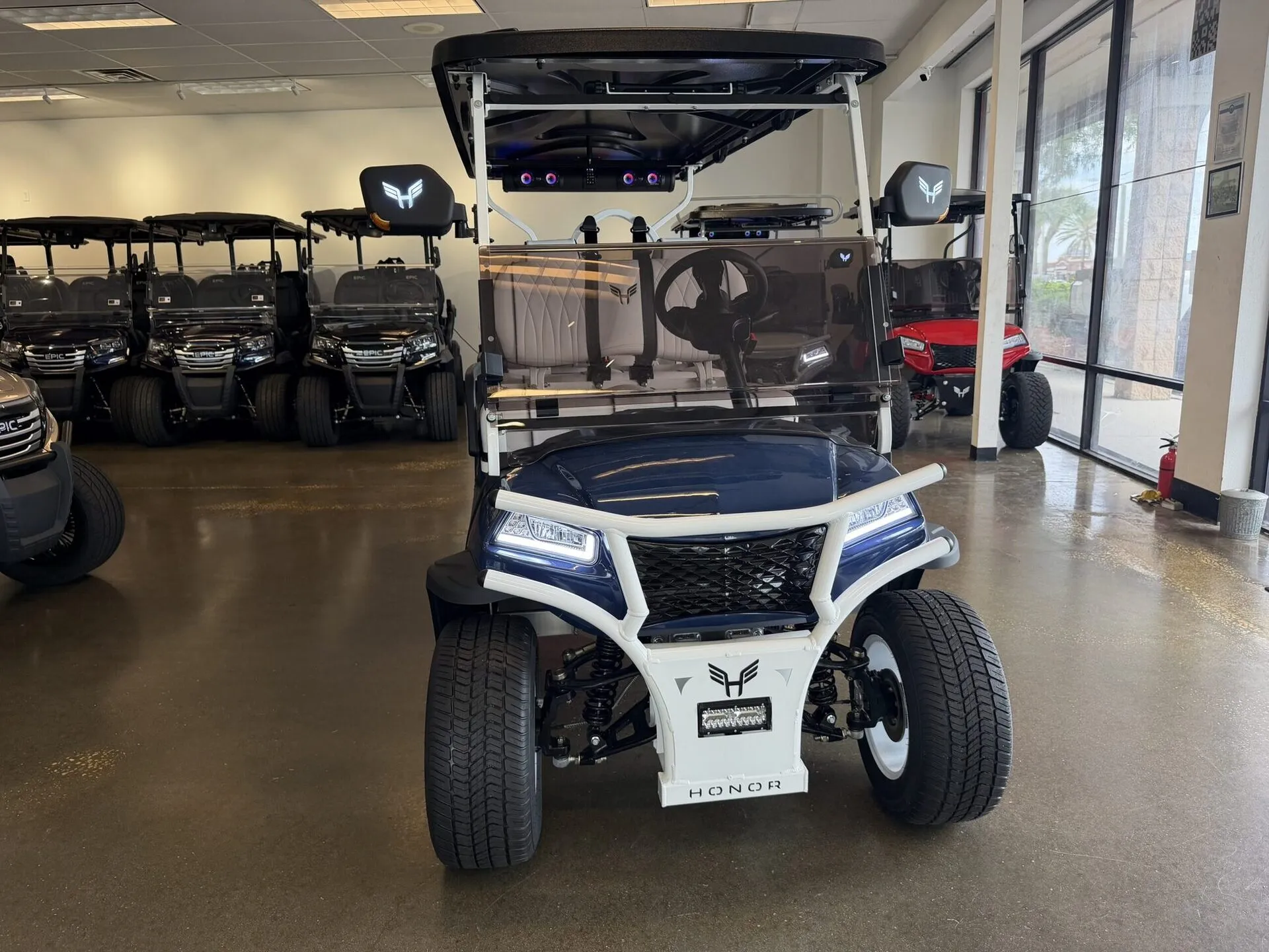 Navy and white Honor G1 with cream tufted leather seats in the showroom