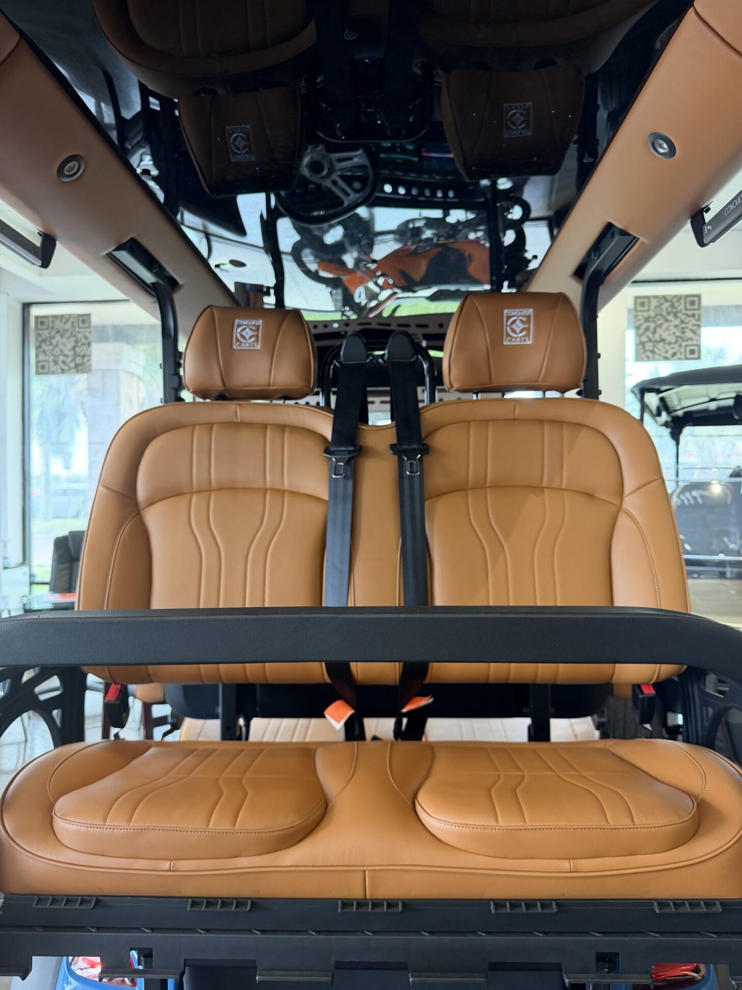 Cognac leather golf cart seats in bright window light