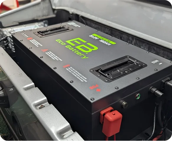 EcoBattery lithium battery pack installed in a golf cart bed